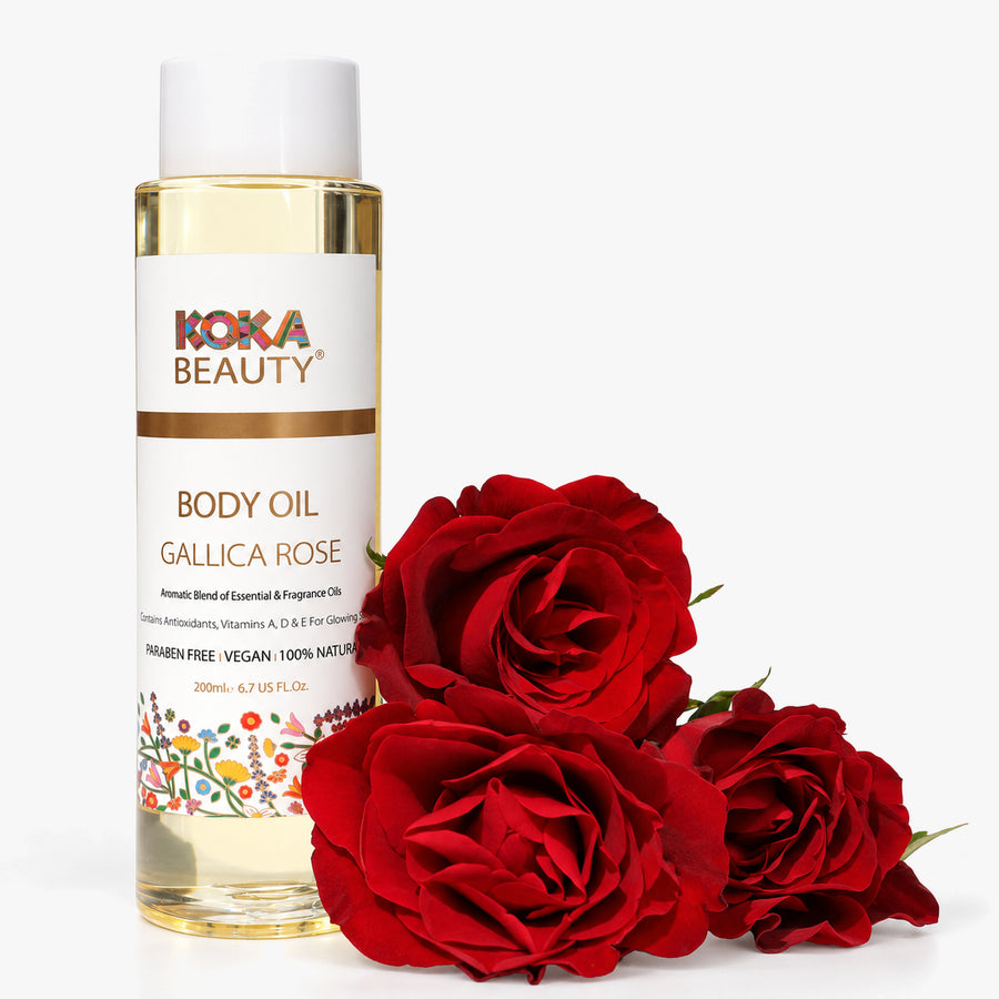 Koka Beauty Gallica Rose Body Oil bottle styled with three deep red roses on white