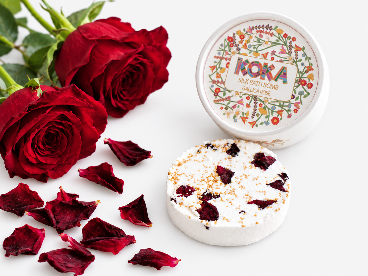 Koka Beauty Gallica Rose silk bath bomb set with a petal-topped disc, illustrated jar and red roses