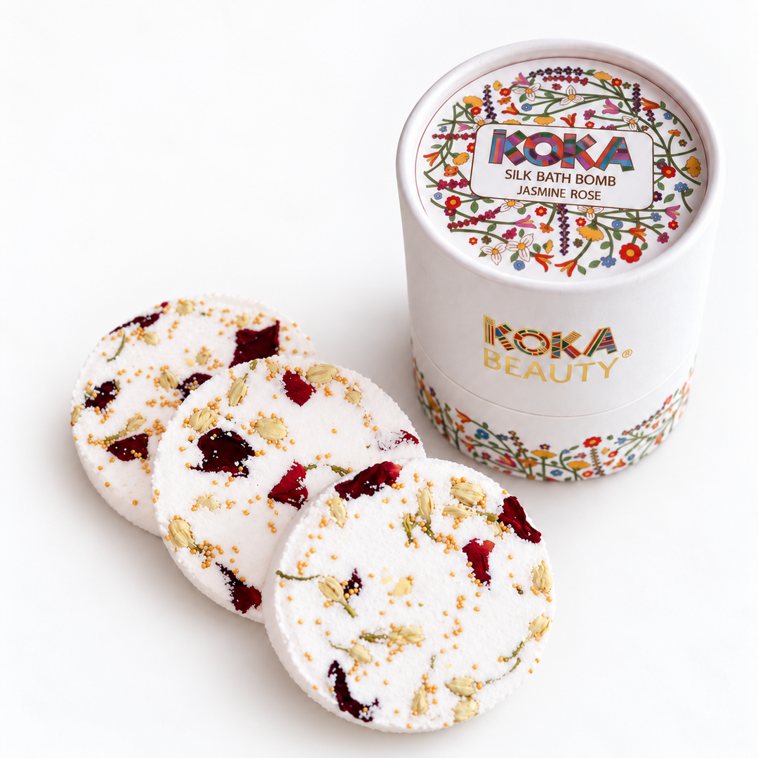 Three Koka Beauty Jasmine Rose silk bath bombs with dried petals and a floral presentation jar