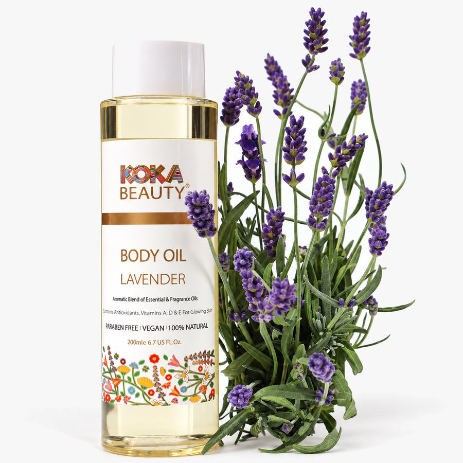 Koka Beauty Lavender Body Oil bottle styled with fresh purple lavender stems on white