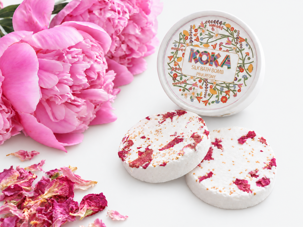 Koka Beauty Pink Peony silk bath bomb set with two petal-topped discs, illustrated jar and peonies