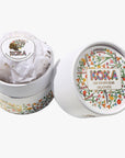 Koka bath bomb in a decorative container on a white background