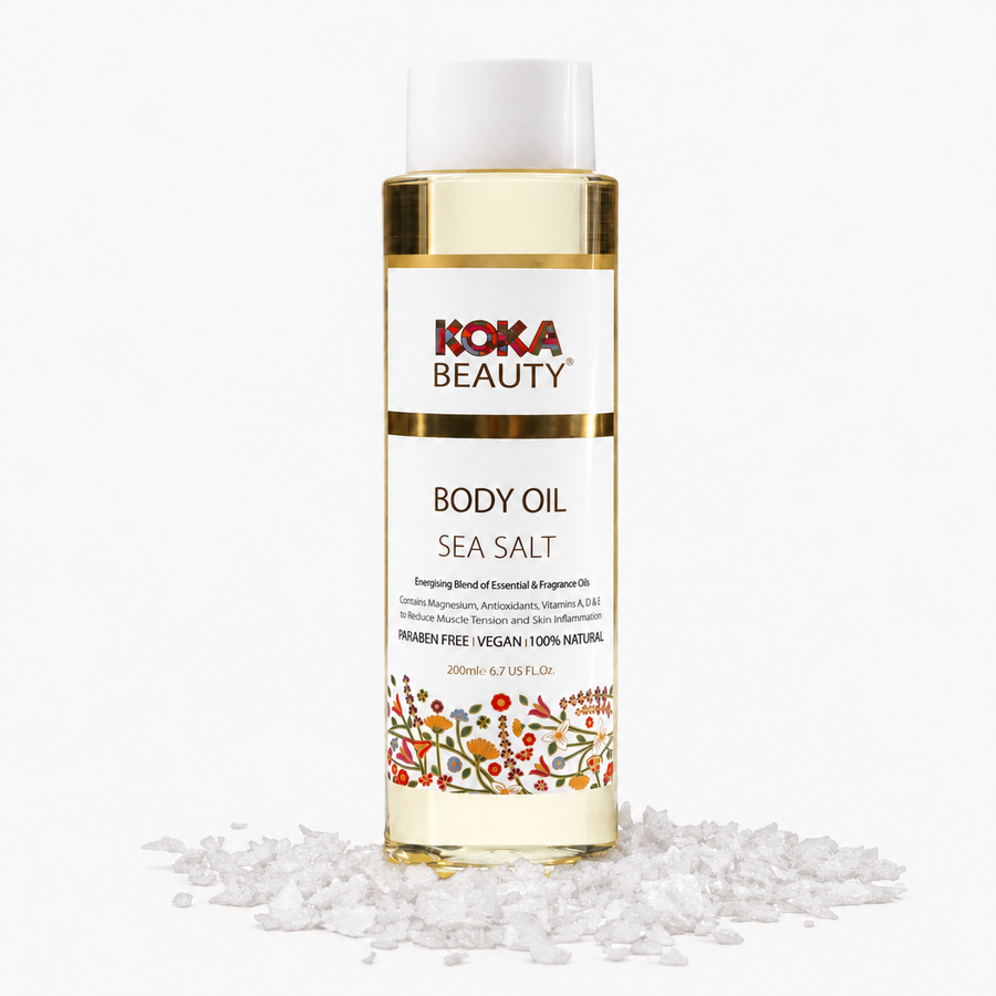 Koka Beauty Sea Salt Body Oil bottle surrounded by coarse sea salt crystals on white