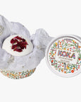 Bath bomb with floral packaging and Poka branding on a white background